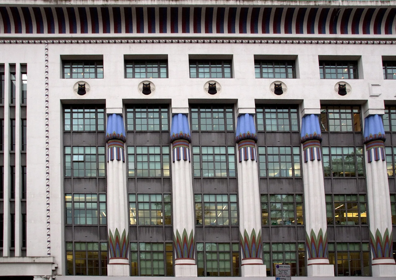 Art deco facade of Greater London House in Camden, with painted Egyptian-style columns and black cat motifs